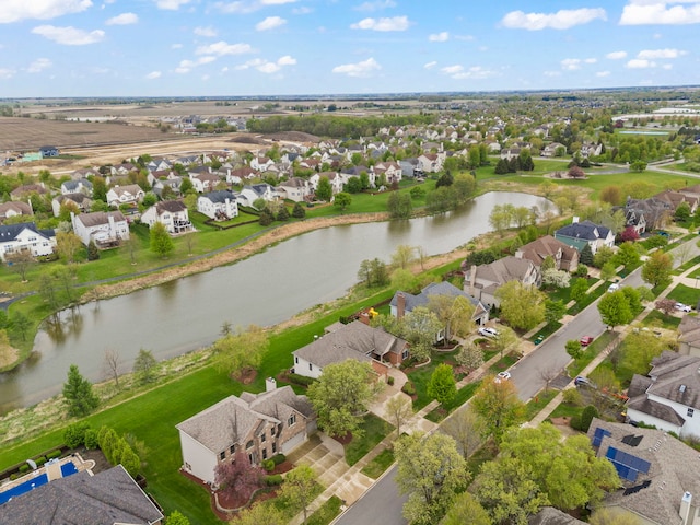 aerial view of residential area featuring a large body of water