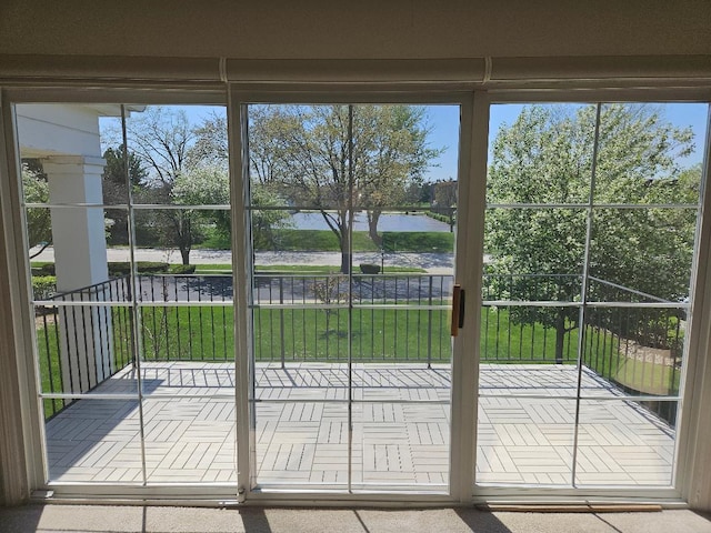 doorway to outside featuring a water view