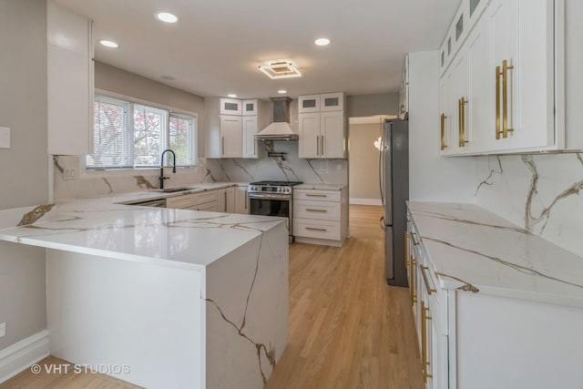 1188 Parkview Ct, Carol Stream, IL 60188 - kitchen with a peninsula, a sink, wall chimney exhaust hood, backsplash, and appliances with stainless steel finishes