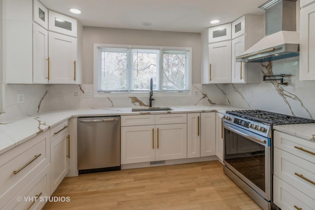 1188 Parkview Ct, Carol Stream, IL 60188 - kitchen with stainless steel appliances, light stone counters, recessed lighting, wall chimney exhaust hood, and white cabinets