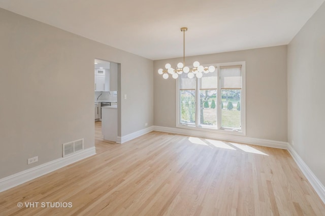 1188 Parkview Ct, Carol Stream, IL 60188 - unfurnished dining area with baseboards, light wood-style floors, an inviting chandelier, and visible vents