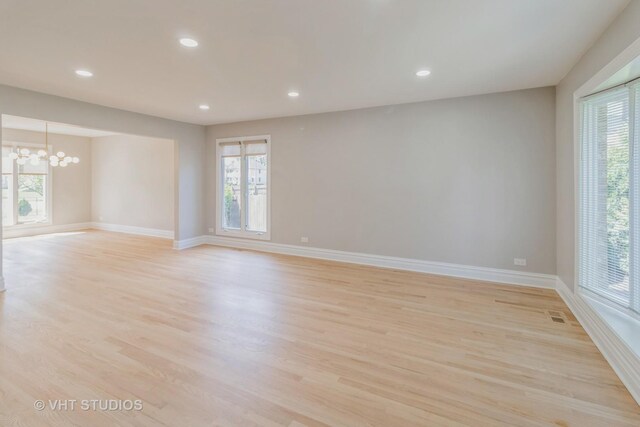 1188 Parkview Ct, Carol Stream, IL 60188 - unfurnished room with baseboards, light wood-style floors, an inviting chandelier, and recessed lighting