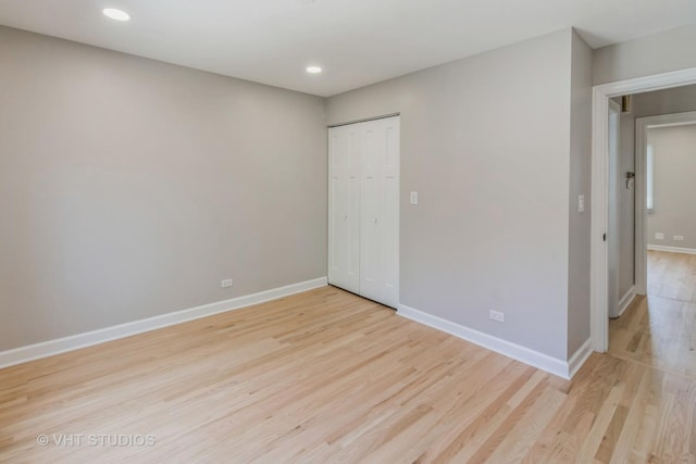 1188 Parkview Ct, Carol Stream, IL 60188 - unfurnished bedroom featuring a closet, light wood-type flooring, baseboards, and recessed lighting