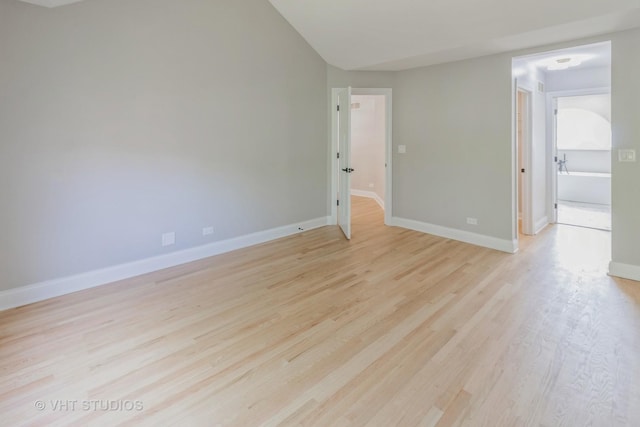 1188 Parkview Ct, Carol Stream, IL 60188 - unfurnished room with baseboards, lofted ceiling, and light wood-type flooring