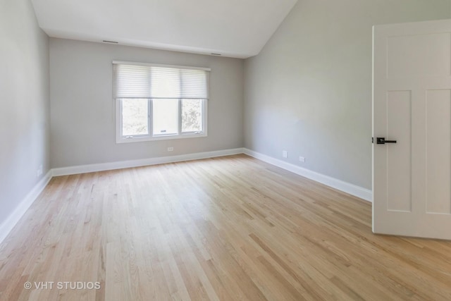 1188 Parkview Ct, Carol Stream, IL 60188 - empty room with baseboards, light wood finished floors, and vaulted ceiling