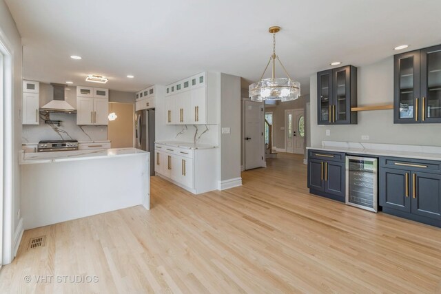 1188 Parkview Ct, Carol Stream, IL 60188 - kitchen with wall chimney range hood, wine cooler, visible vents, light wood finished floors, and appliances with stainless steel finishes