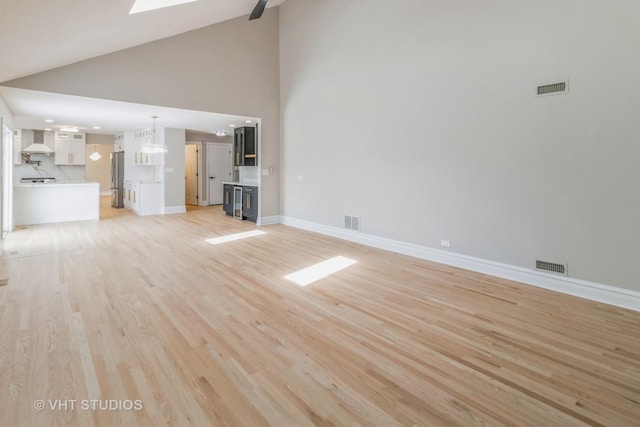 1188 Parkview Ct, Carol Stream, IL 60188 - unfurnished living room featuring light wood-type flooring, visible vents, and high vaulted ceiling
