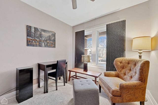 sitting room featuring a ceiling fan, carpet flooring, and baseboards