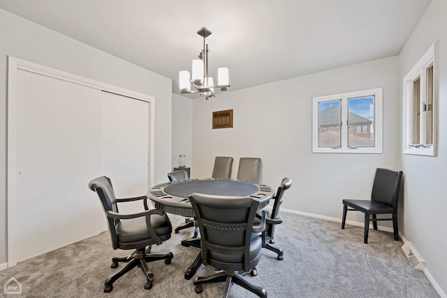 carpeted dining space with an inviting chandelier, visible vents, and baseboards