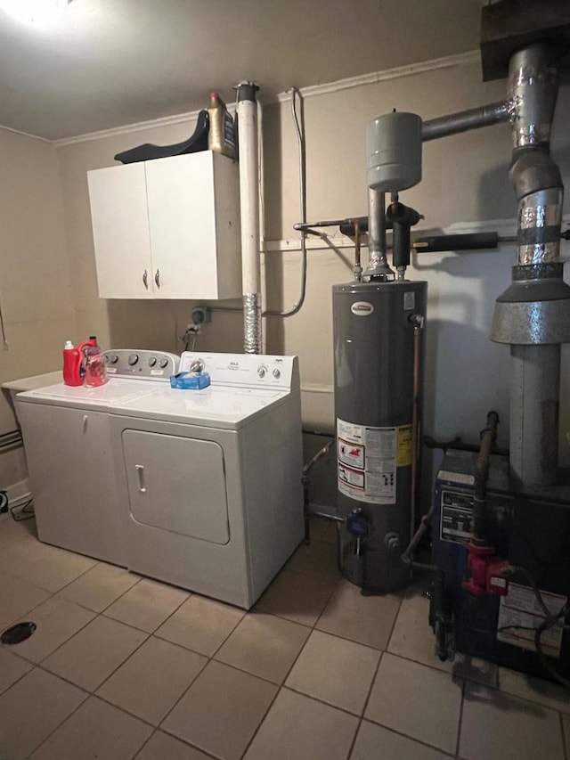 laundry area with gas water heater, separate washer and dryer, cabinet space, light tile patterned floors, and crown molding