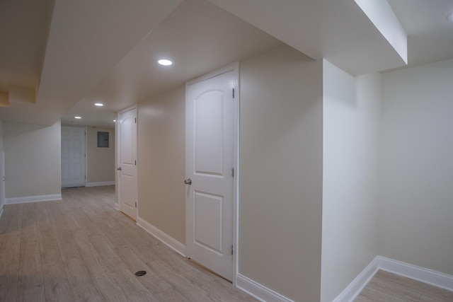 hall with recessed lighting, baseboards, and light wood-type flooring