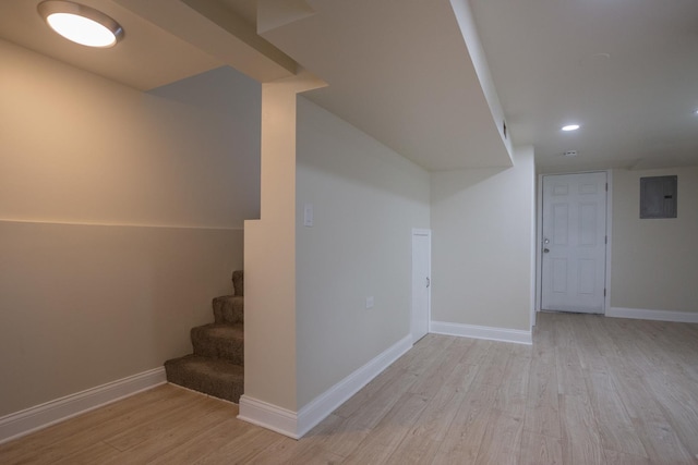 finished basement with light wood finished floors, recessed lighting, stairway, and baseboards