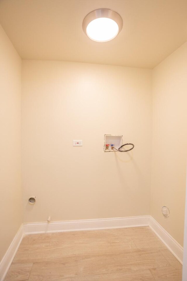 laundry room with hookup for a washing machine, laundry area, light wood-style flooring, gas dryer hookup, and baseboards