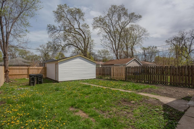 view of yard with a storage unit, a fenced backyard, and an outdoor structure