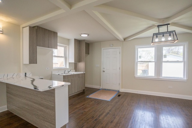 kitchen featuring baseboards, a peninsula, dark wood-style flooring, and light stone counters