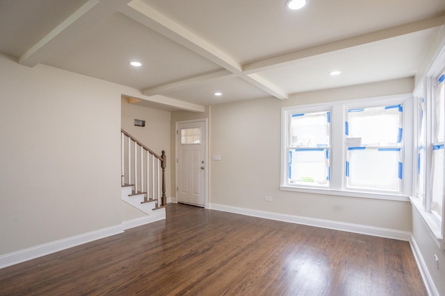 entryway with baseboards, beam ceiling, a wealth of natural light, and dark wood finished floors