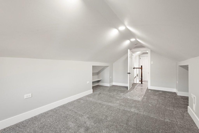 additional living space featuring lofted ceiling, carpet, and baseboards