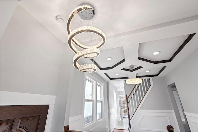 details featuring recessed lighting, coffered ceiling, a decorative wall, wainscoting, and a notable chandelier