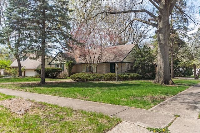 ranch-style house featuring a front yard and a garage
