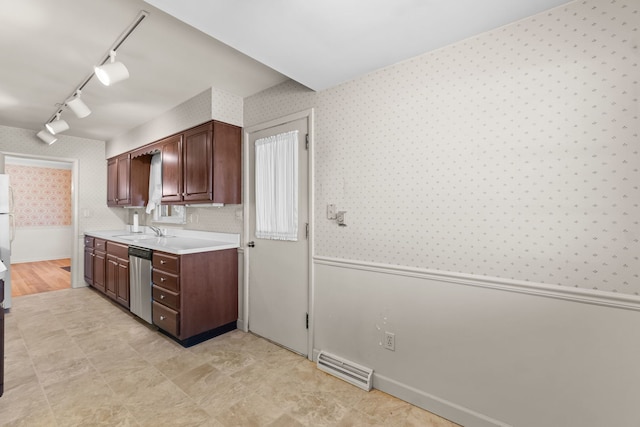 kitchen with a sink, visible vents, light countertops, stainless steel dishwasher, and wallpapered walls