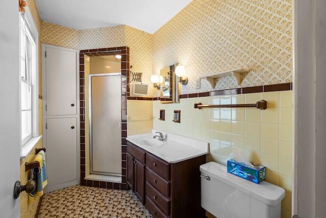 bathroom featuring toilet, a shower stall, and a wealth of natural light