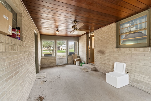 unfurnished sunroom with a ceiling fan