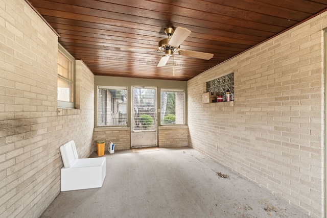 unfurnished sunroom with a ceiling fan