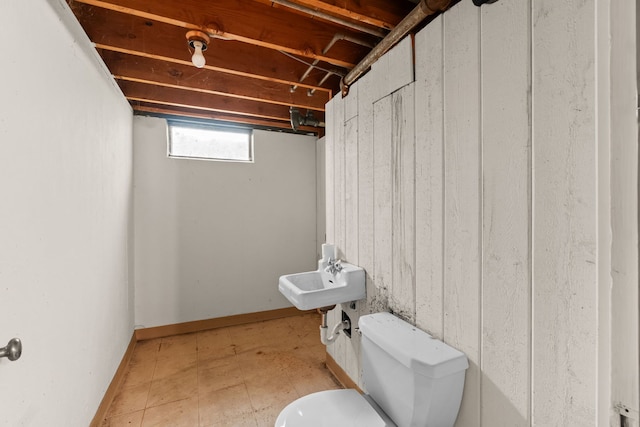 half bathroom featuring toilet and a sink