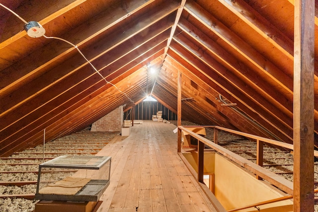 unfinished attic featuring an upstairs landing