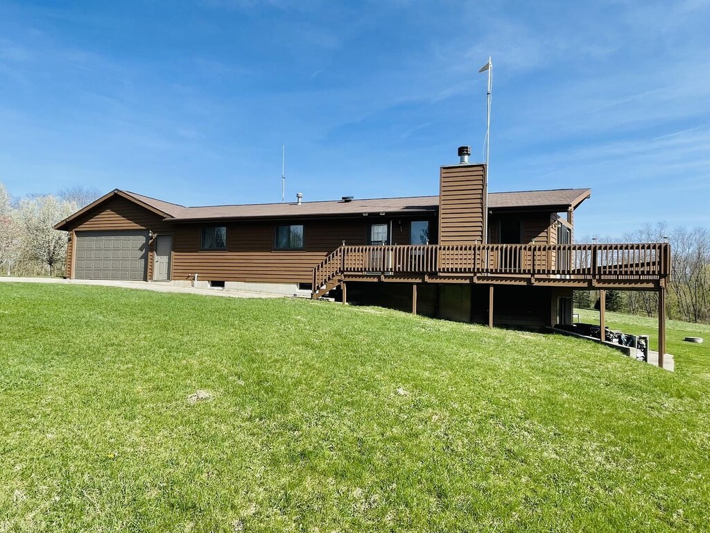 19-28 Hidden Valley Dr, Lanark, IL 61046 - rear view of property featuring a deck, a yard, a chimney, and a garage