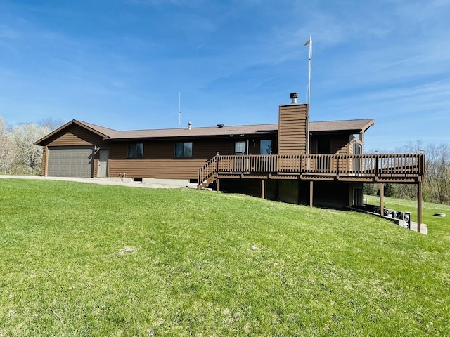 rear view of property featuring a deck, a yard, a chimney, and a garage