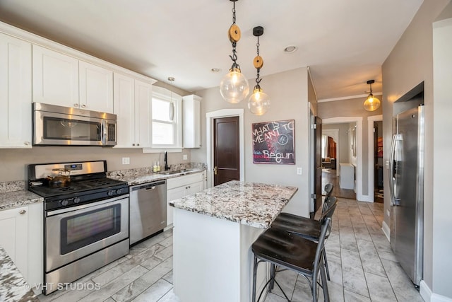 3211 Scoville Ave, Berwyn, IL 60402 - kitchen with a breakfast bar, a sink, stainless steel appliances, white cabinetry, and a kitchen island