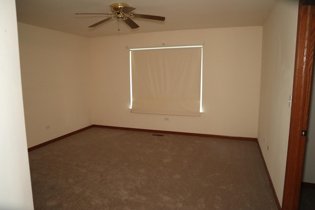 spare room with ceiling fan, carpet floors, and baseboards