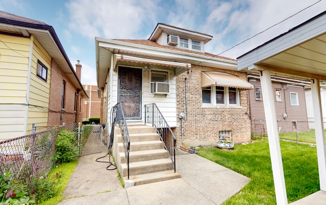 view of front of home featuring brick siding and a gate