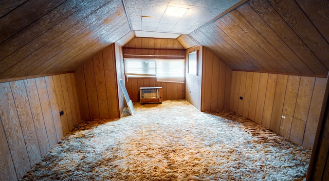 bonus room with wood walls, carpet flooring, lofted ceiling, and heating unit