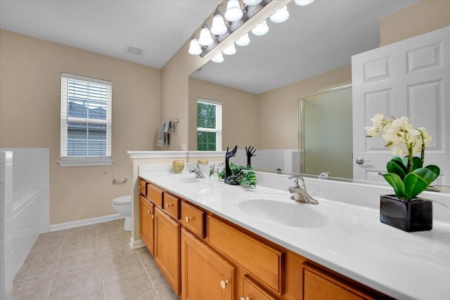 bathroom featuring a sink, double vanity, tile patterned floors, baseboards, and visible vents