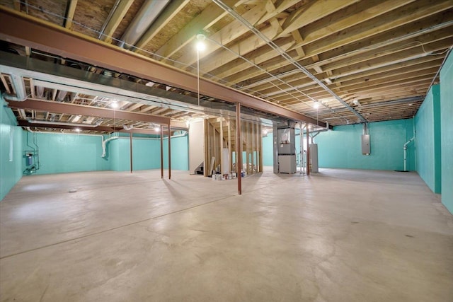 unfinished below grade area with heating unit and electric panel