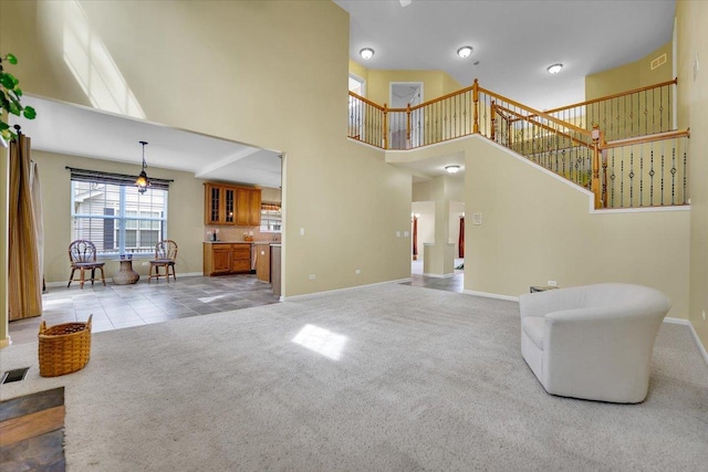 spare room featuring baseboards, carpet, and a notable chandelier