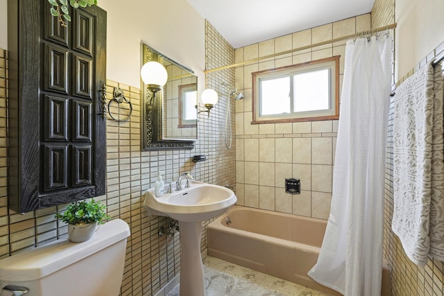 full bath with toilet, shower / bath combination with curtain, and tile walls