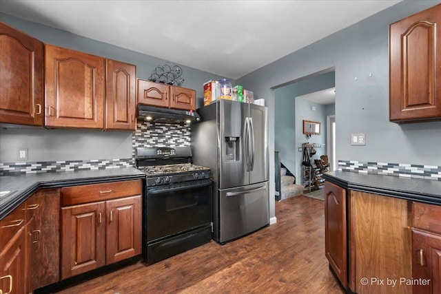 5214 Abbey Dr, Mchenry, IL 60050 - kitchen featuring black range with gas stovetop, under cabinet range hood, stainless steel refrigerator with ice dispenser, dark countertops, and backsplash