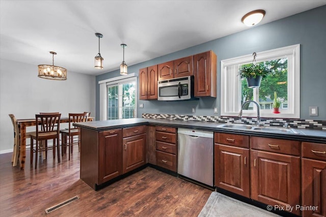 5214 Abbey Dr, Mchenry, IL 60050 - kitchen with appliances with stainless steel finishes, dark countertops, a sink, and dark wood-type flooring