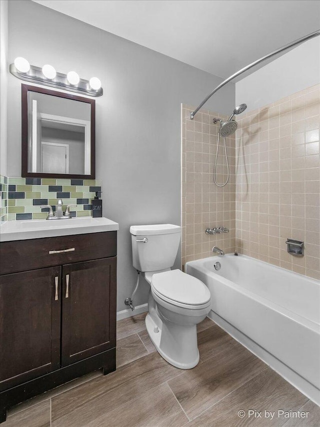 5214 Abbey Dr, Mchenry, IL 60050 - full bathroom with toilet, tub / shower combination, vanity, wood finished floors, and decorative backsplash
