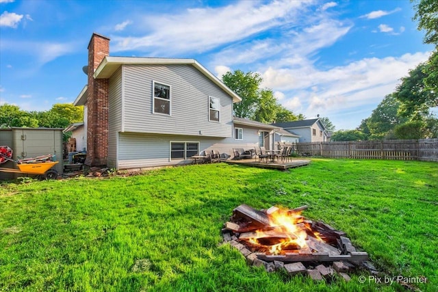 5214 Abbey Dr, Mchenry, IL 60050 - back of property with an outdoor fire pit, a chimney, and a patio area