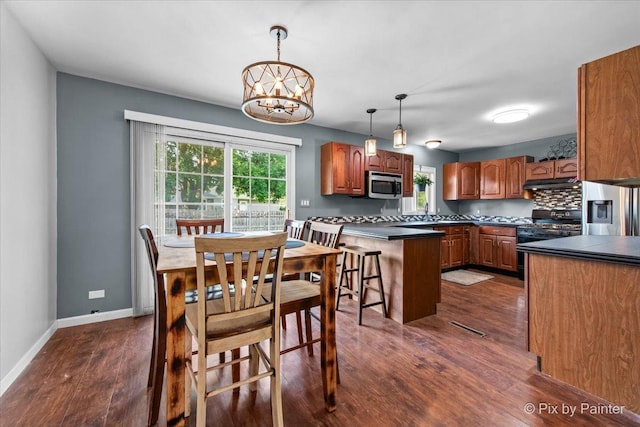 5214 Abbey Dr, Mchenry, IL 60050 - dining space with dark wood-style floors, a chandelier, and baseboards