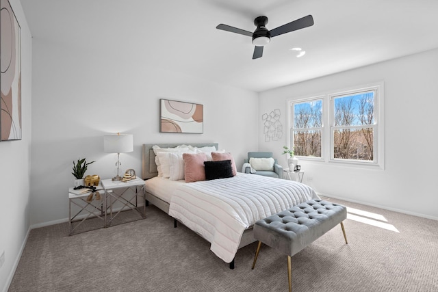 bedroom with a ceiling fan, carpet flooring, and baseboards