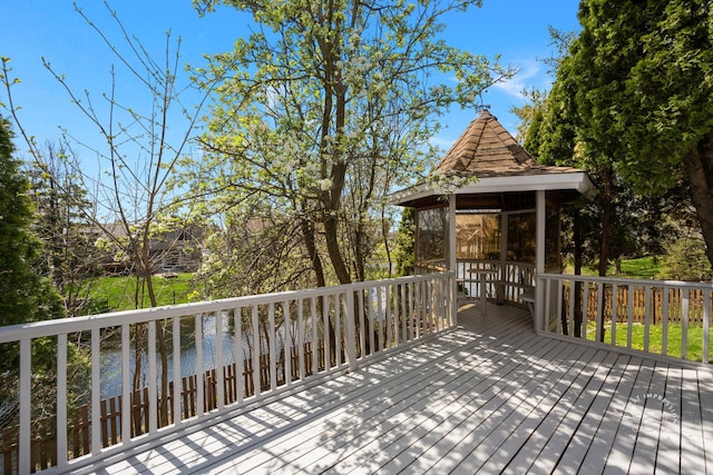 wooden deck with a gazebo and a water view
