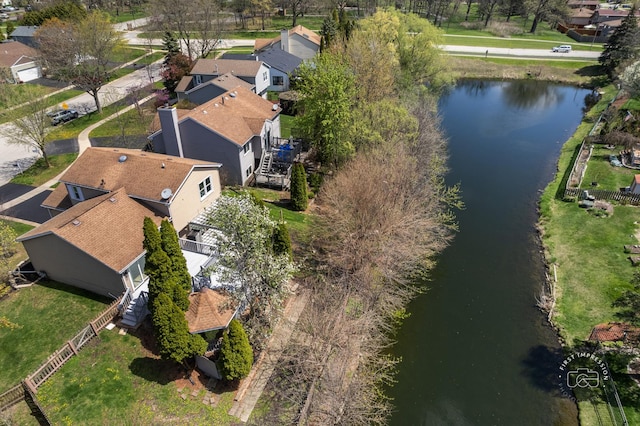 drone / aerial view with a residential view and a water view