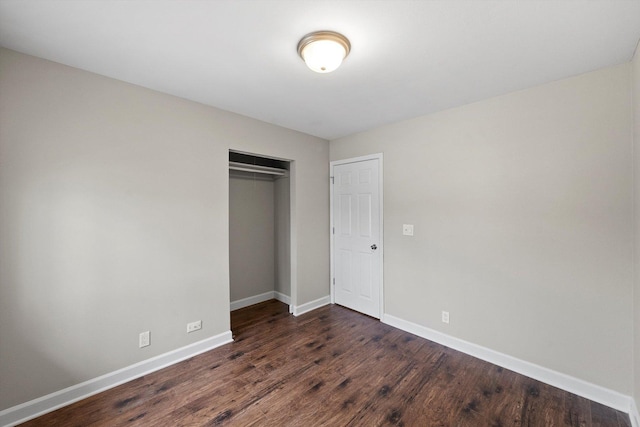 511 Freeman Ave, Streamwood, IL 60107 - unfurnished bedroom with baseboards, a closet, and dark wood-type flooring