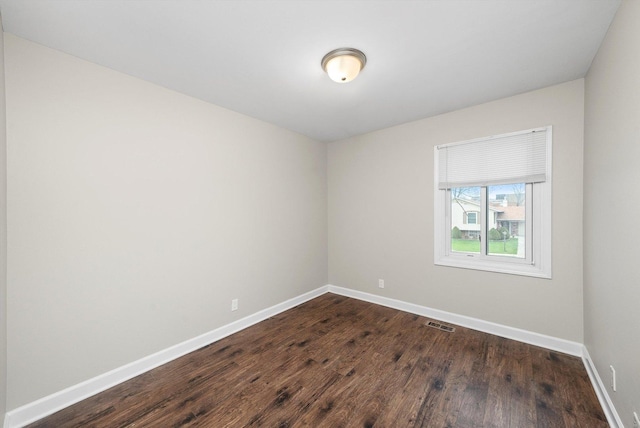 511 Freeman Ave, Streamwood, IL 60107 - unfurnished room featuring baseboards, dark wood-type flooring, and visible vents