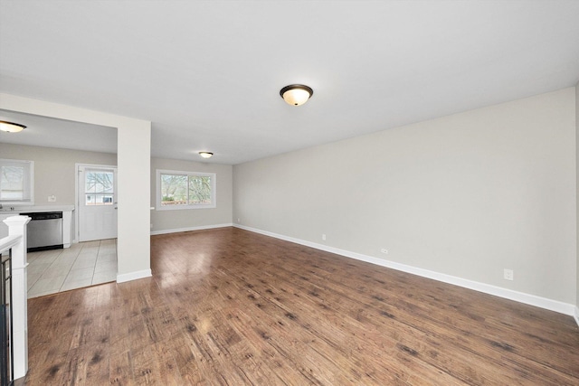 511 Freeman Ave, Streamwood, IL 60107 - unfurnished living room featuring baseboards and wood finished floors